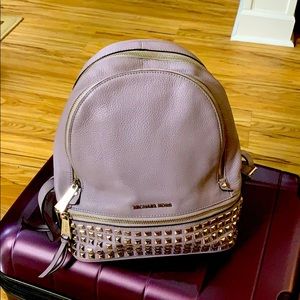 Micheal Kors medium grommet leather backpack.